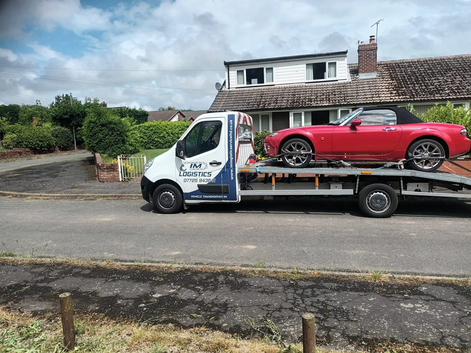 IM Logistics recovery truck transporting a red Mazda MX-5 — 24/7 car recovery in Stockport