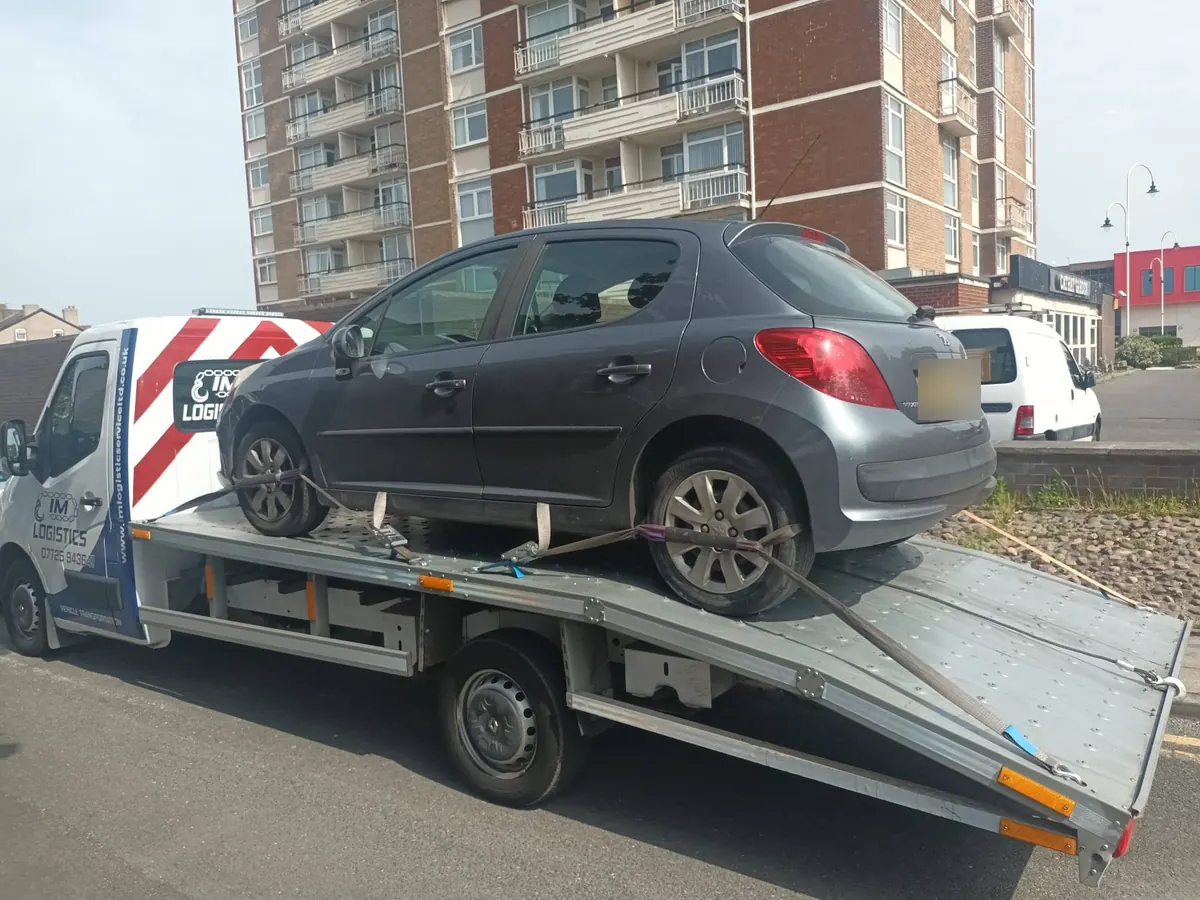 Grey Peugeot 207 on IM Logistics recovery truck — car breakdown recovery North West