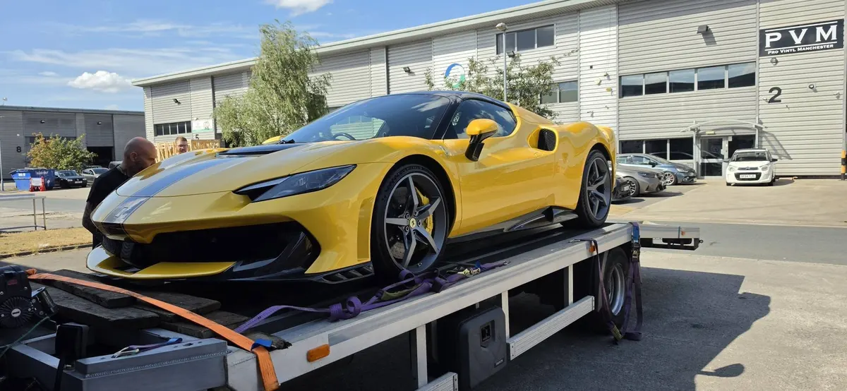 Ferrari strapped onto IM Logistics recovery truck — specialist prestige vehicle transportation